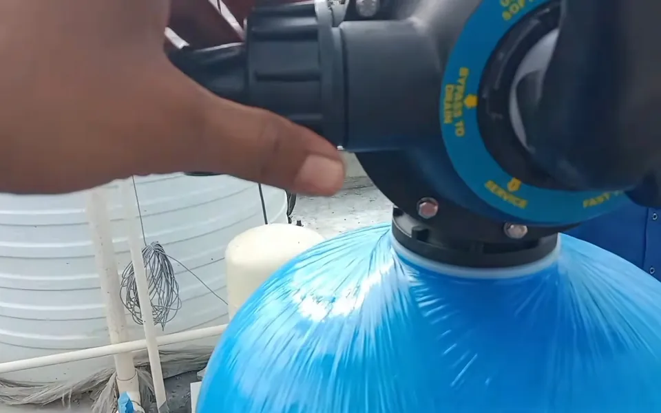 Technician adjusting the control valve on a treatment tank for water softener vs water conditioner in Laguna Niguel