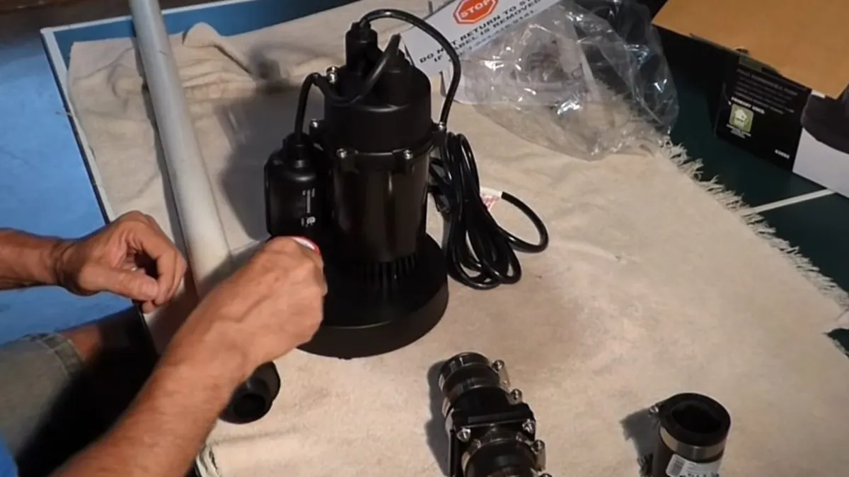 Technician assembling a sump pump and discharge fitting for residential plumbing service in Pacific Island, Laguna Niguel