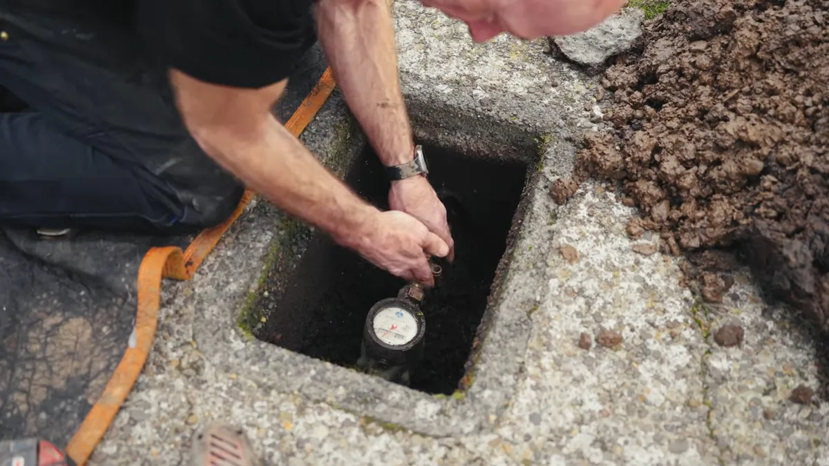 Pressure gauge connected at a buried water service line for water line repair replacement in Laguna Niguel