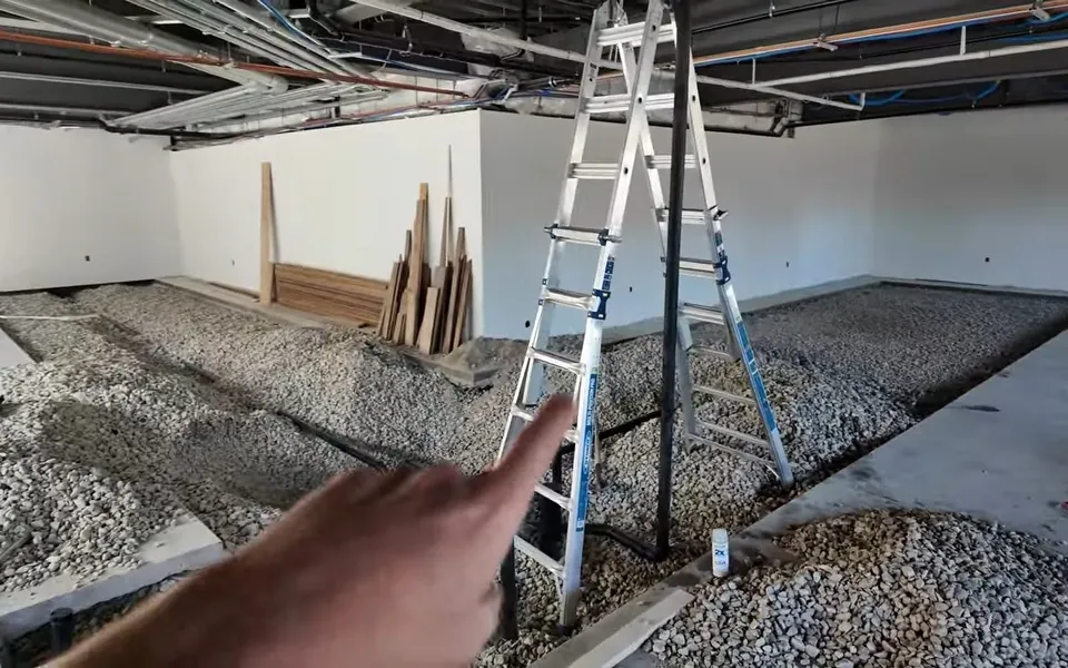 Commercial drain rough-in layout across a gravel floor for residential plumbing service in South Orange County