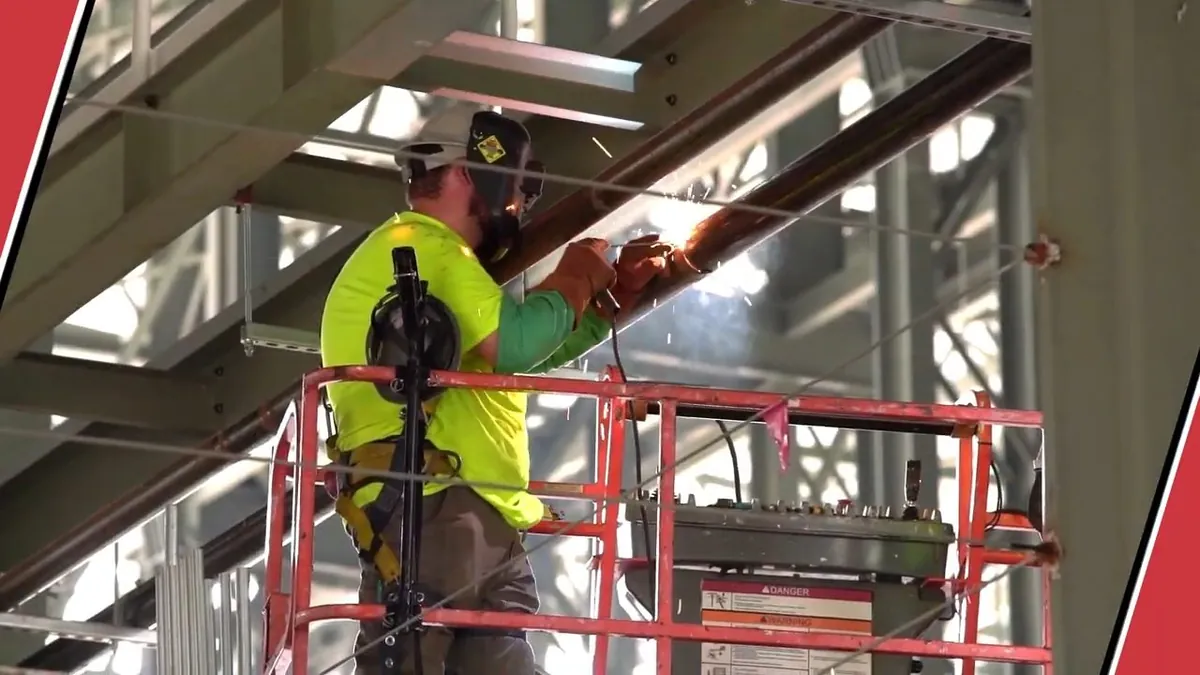 Worker on a lift installing overhead commercial piping for commercial plumbing in Laguna Niguel