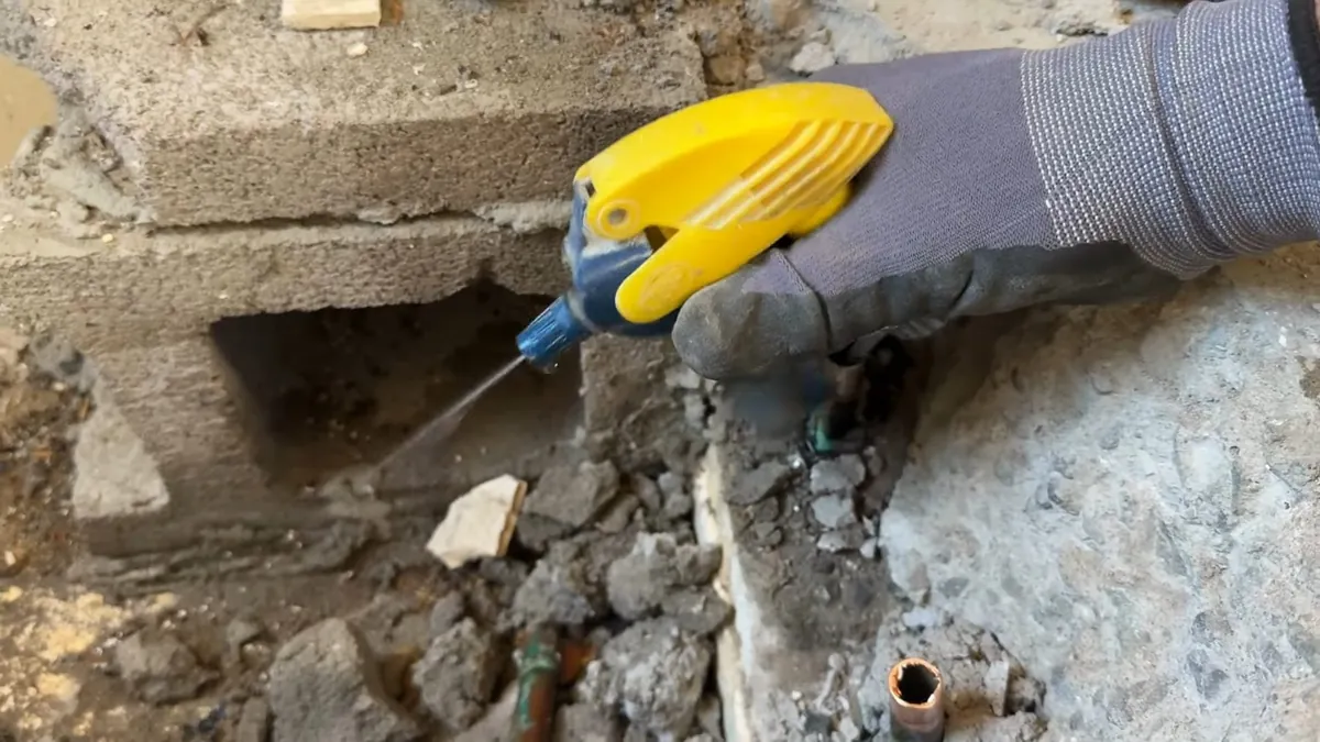 Technician drilling a small access opening in concrete for slab leak detection what to expect in Laguna Niguel