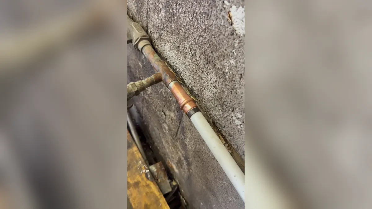 Copper water line repaired with a new wall-mounted coupling for residential plumbing service in Marina Hills, Laguna Niguel