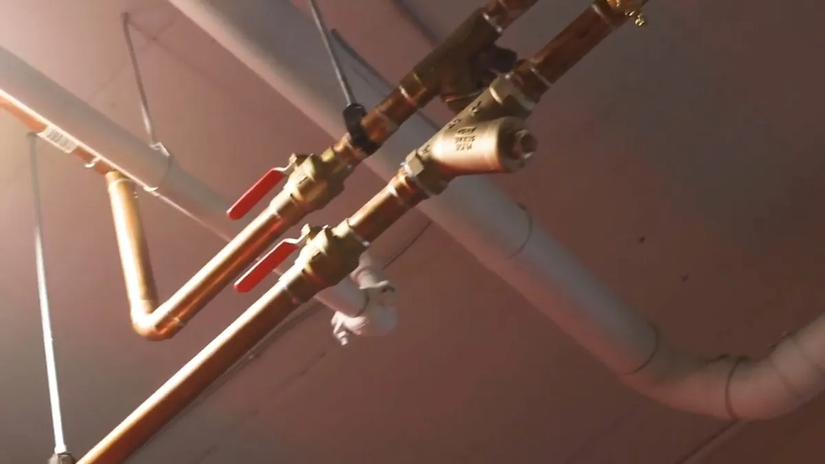 Copper and PEX supply lines routed across an open ceiling for repiping whole home pipe replacement in Laguna Niguel