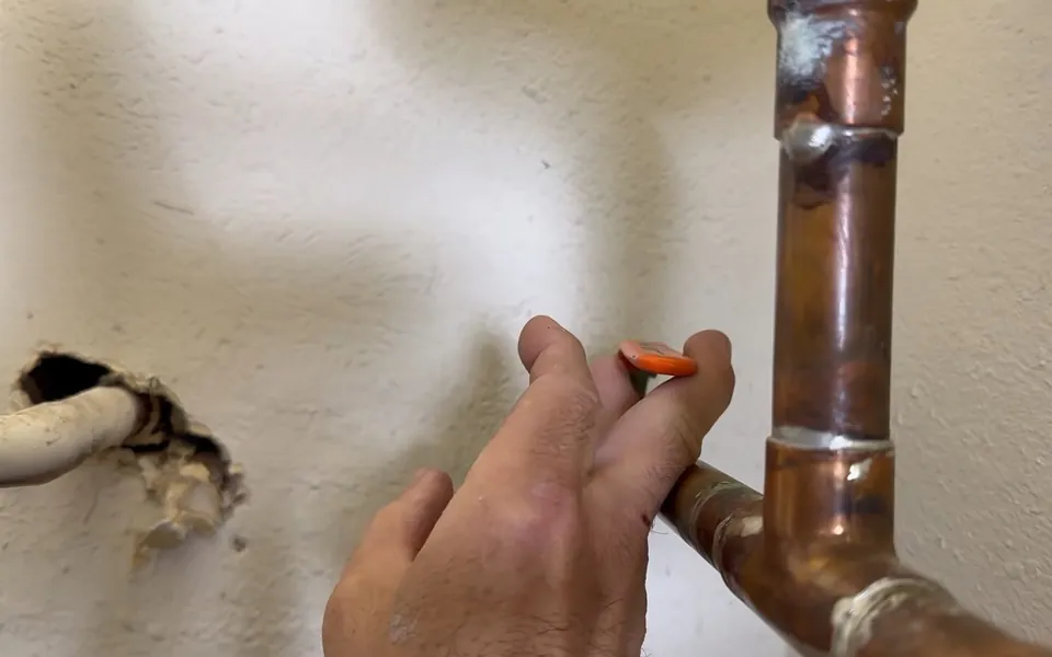 Copper pipe and shutoff valve installed near a wall for slab leak detection repair in Laguna Niguel