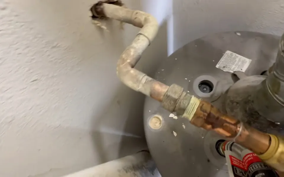 Corroded anode rod connection at the top of a water heater for residential plumbing service in Lake Forest