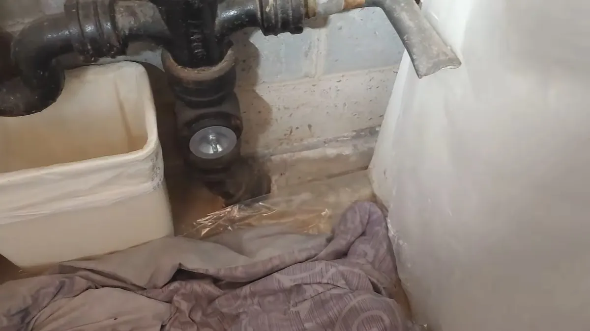 Corroded cast iron pipe joint near the floor for residential plumbing service in Laguna Beach