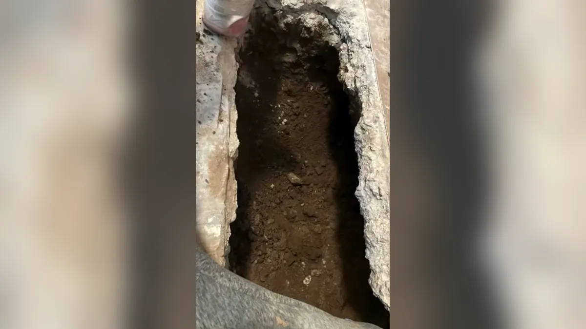 Deep floor trench exposing underground plumbing for residential plumbing service in El Niguel, Laguna Niguel