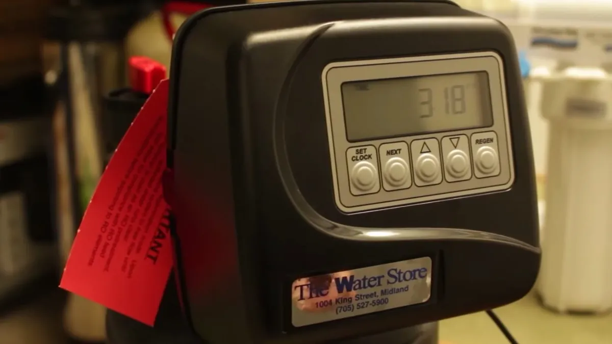 Digital water softener control panel being programmed for residential plumbing service in Aliso Viejo