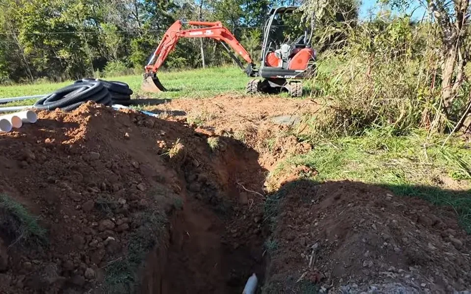 Excavator opening a trench for sewer line replacement for sewer line repair in Laguna Niguel