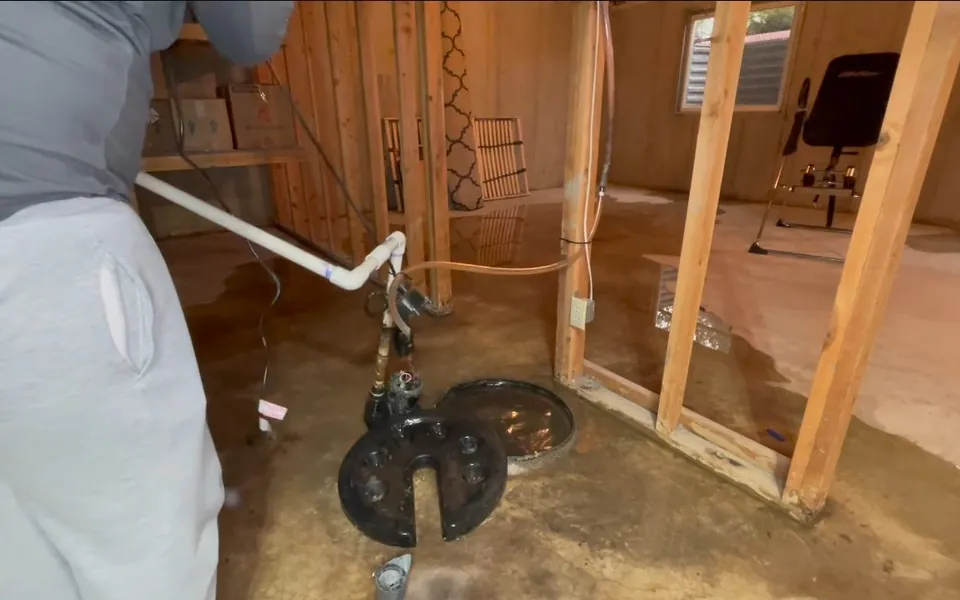 Exposed pump and piping in an unfinished framed room for residential plumbing service in Newport Coast