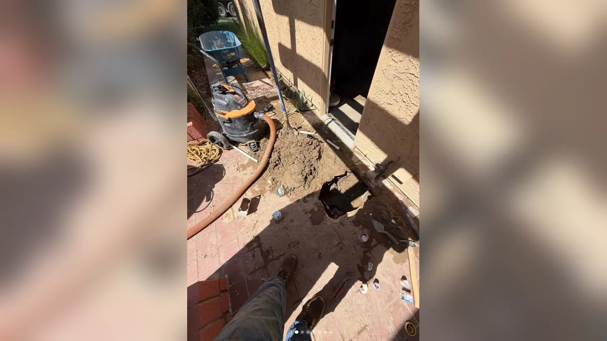 Exterior slab access opened beside plumbing tools for residential plumbing service in Beacon Hill, Laguna Niguel