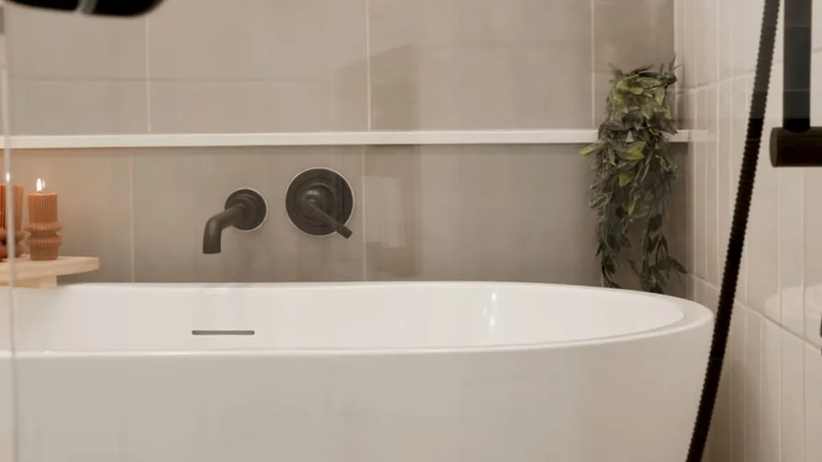 Freestanding bathtub with a wall-mounted faucet for residential plumbing service in Newport Coast