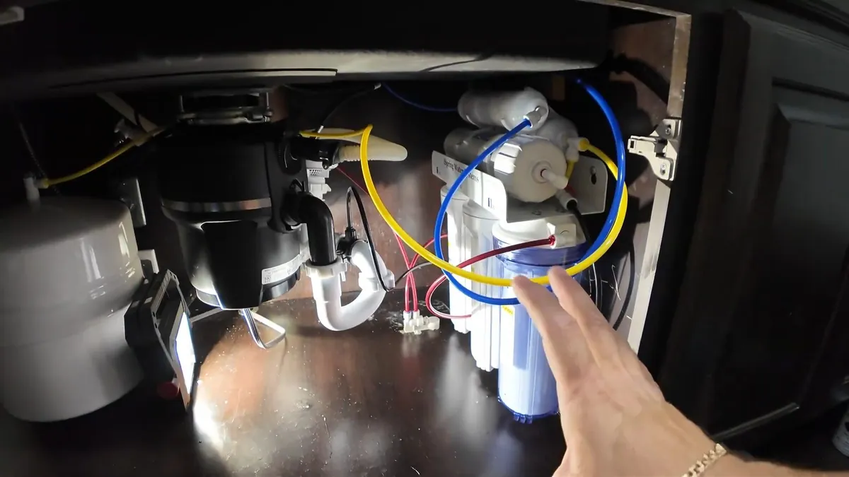 Garbage disposal and filtration lines beneath a kitchen sink for garbage disposal installation repair in Laguna Niguel