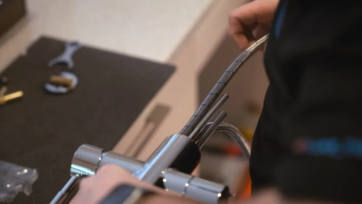 Technician handling a kitchen faucet during repair for faucet repair installation in Laguna Niguel