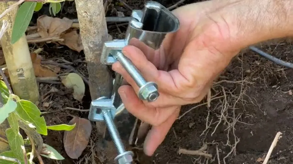 Repair clamp positioned on a damaged metal sprinkler pipe for outdoor plumbing services in Laguna Niguel