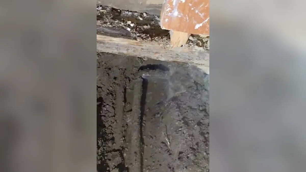 Narrow trench cut through a concrete floor for residential plumbing service in Bear Brand Ranch, Laguna Niguel