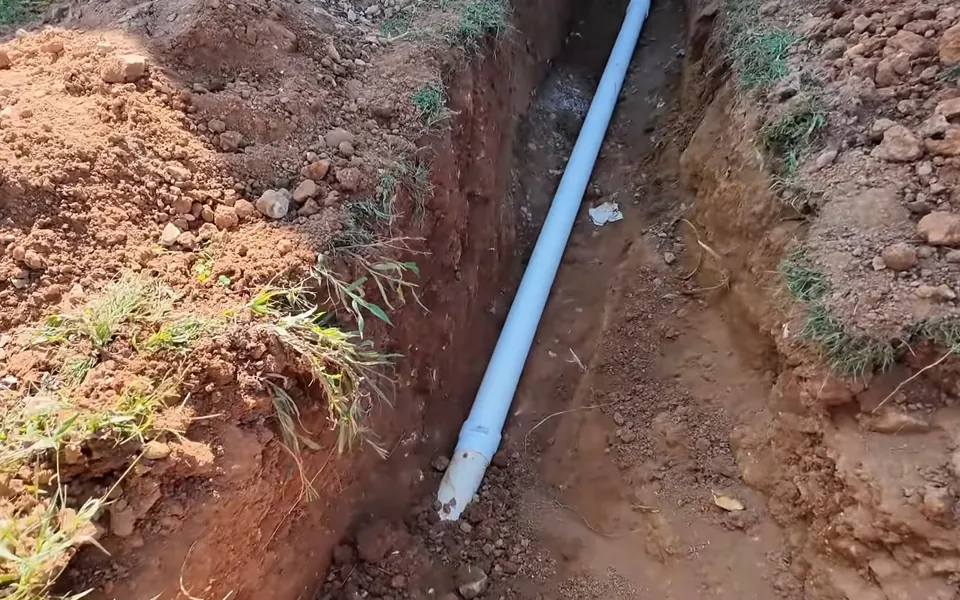 New PVC sewer line installed inside an open trench for water line repair replacement in Laguna Niguel