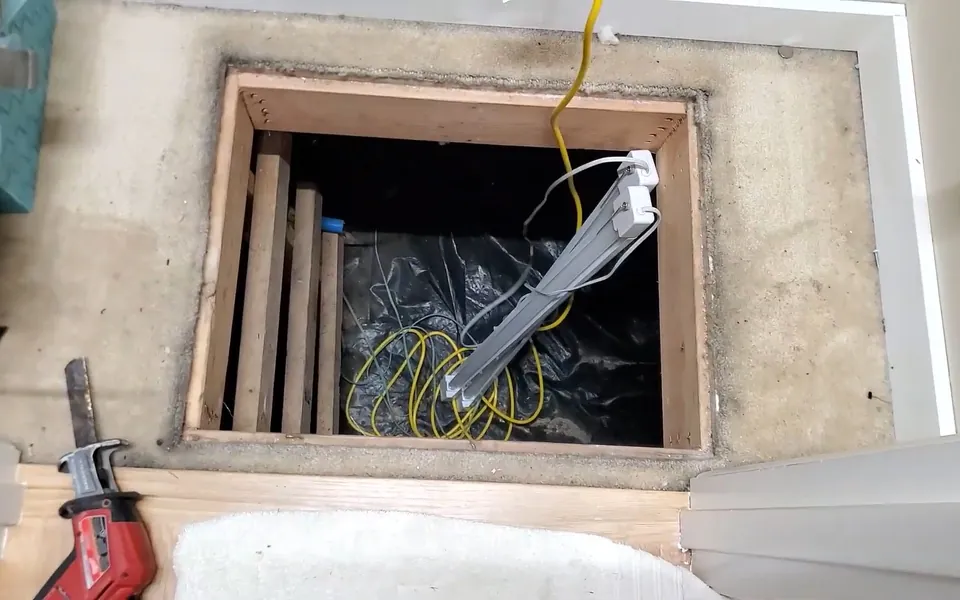 Open crawlspace access beneath a home for residential plumbing service in San Juan Capistrano