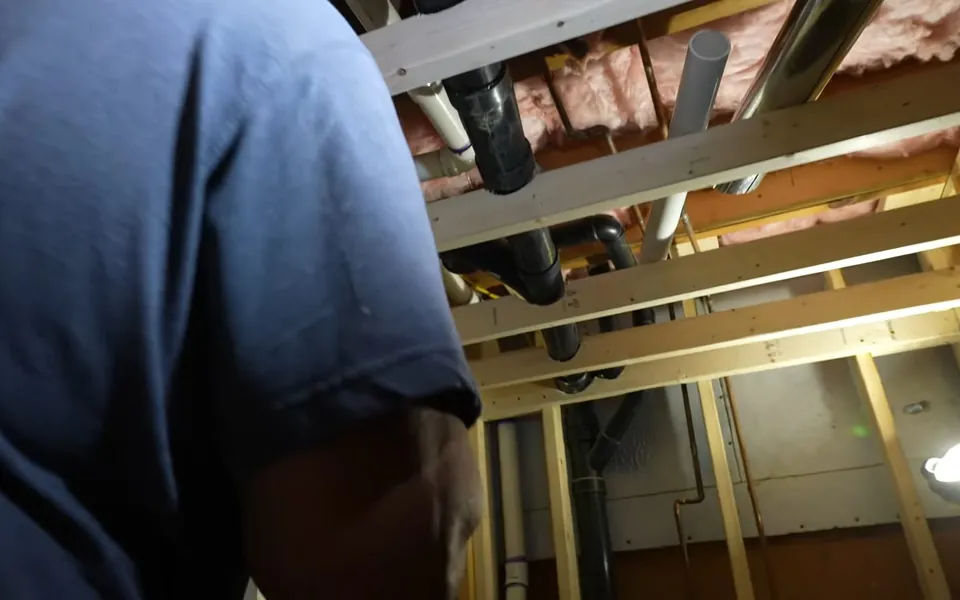 Plumber inspecting overhead plumbing rough-in lines for index.html in Laguna Niguel