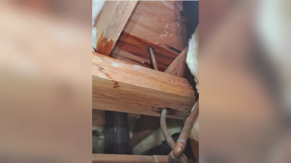 Water pipe routed through open wall framing for residential plumbing service in Hidden Hills, Laguna Niguel