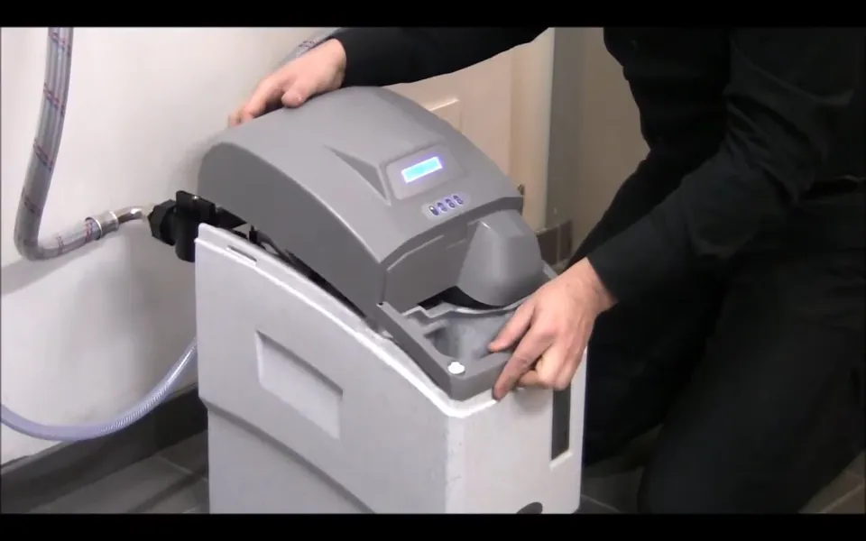 Technician programming a residential water softener for residential plumbing service in Rancho Niguel, Laguna Niguel