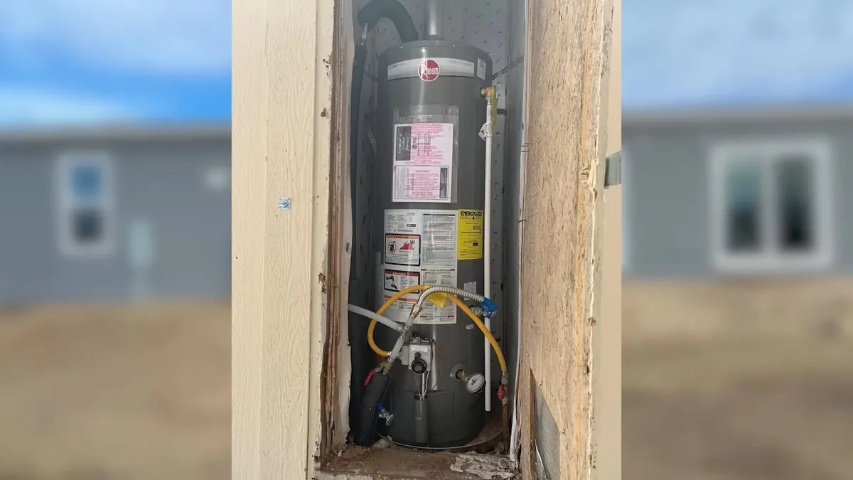 Tank water heater installed inside a wall recess for preventive plumbing maintenance in Laguna Niguel