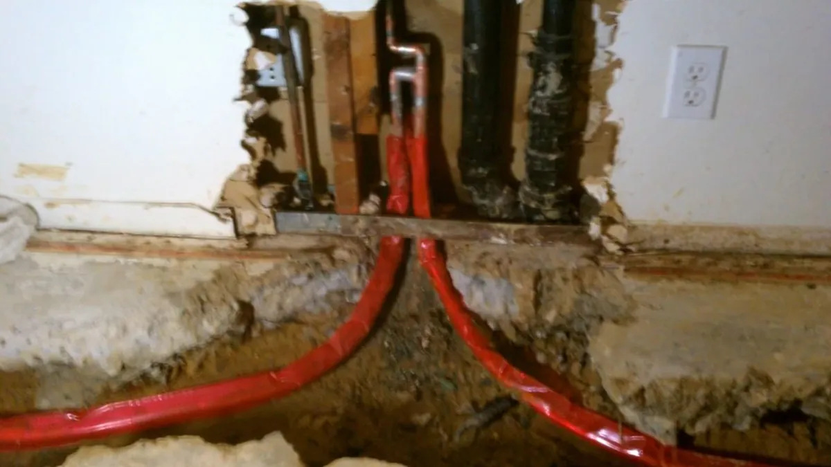 Red PEX water lines installed inside an opened wall for when is it time to repipe your home in Laguna Niguel