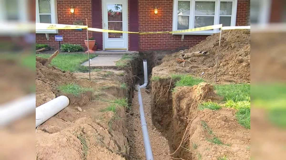 Sewer pipe excavation running beside a house for trenchless sewer repair in Laguna Niguel