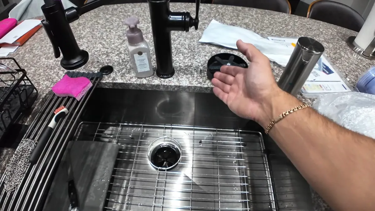 Stainless kitchen sink with faucet parts arranged nearby for kitchen plumbing in Laguna Niguel