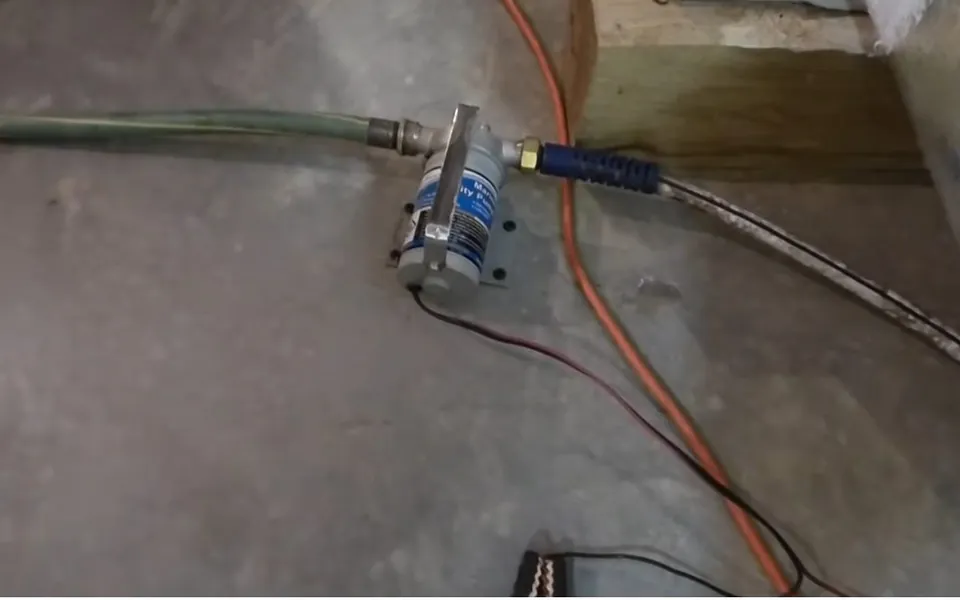 Sump pump and pressure gauge positioned on a floor for hillside pool leaks in Laguna Niguel