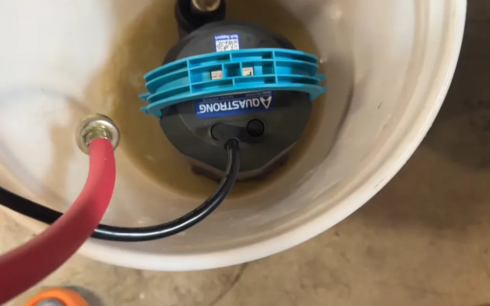 Circulation pump and hoses in a tankless flushing bucket for tankless water heater descaling in Laguna Niguel