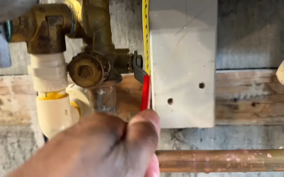 Technician opening a tankless water heater service valve for MNWD water hardness and your plumbing in Laguna Niguel