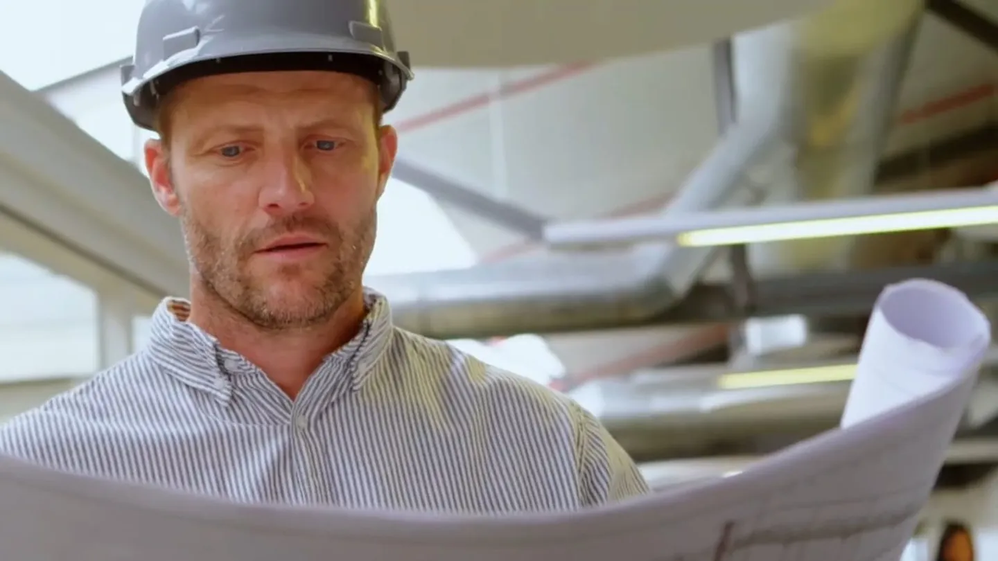 Technician reviewing plumbing plans at a jobsite for plumbing service in Laguna Niguel