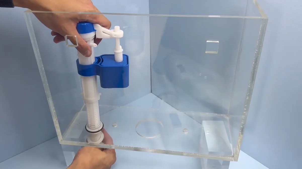 Toilet tank fill and flush valve being installed for toilet repair replacement in Laguna Niguel