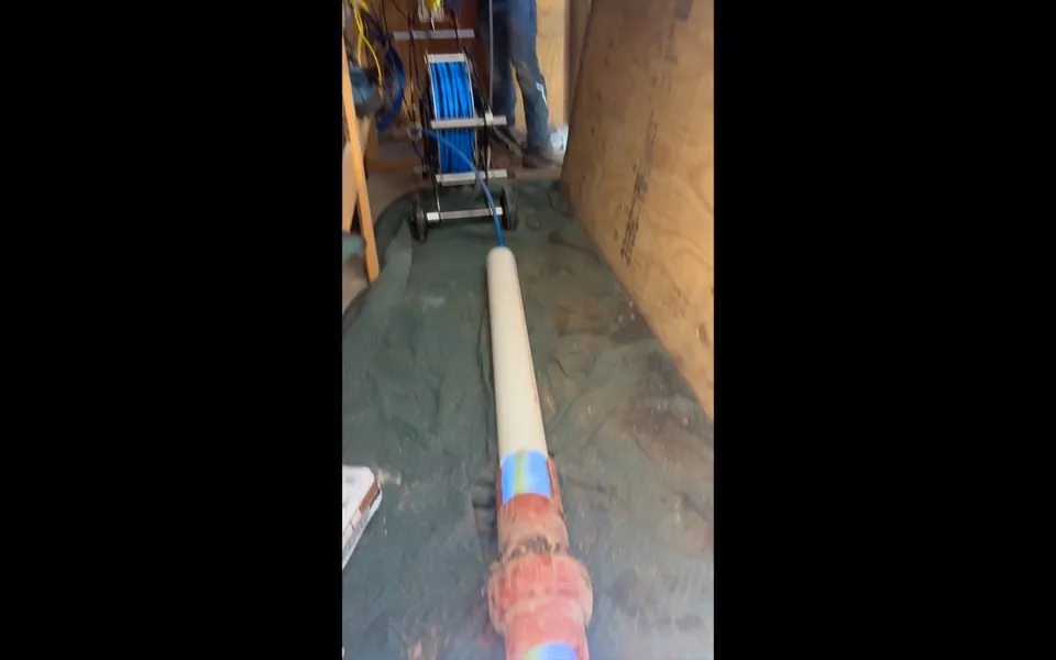 Liner hose routed through a confined sewer access area for residential plumbing service in Salt Creek, Laguna Niguel