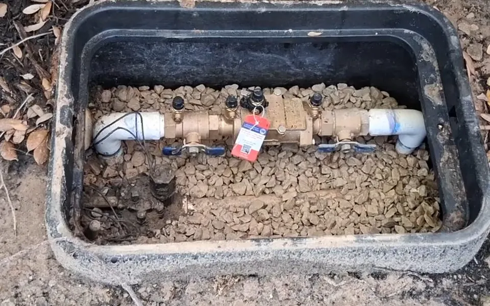 Backflow prevention valve inside an underground access box for backflow prevention testing in Laguna Niguel