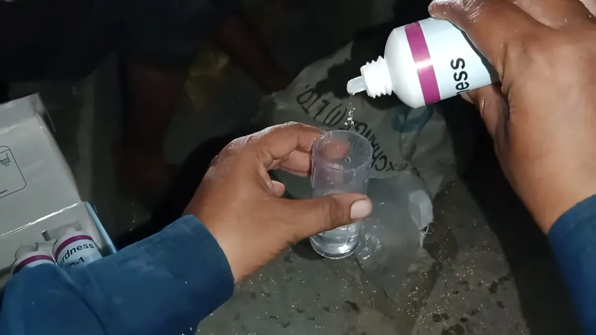 Drop test being performed on a clear water sample for pool leak vs evaporation in Laguna Niguel