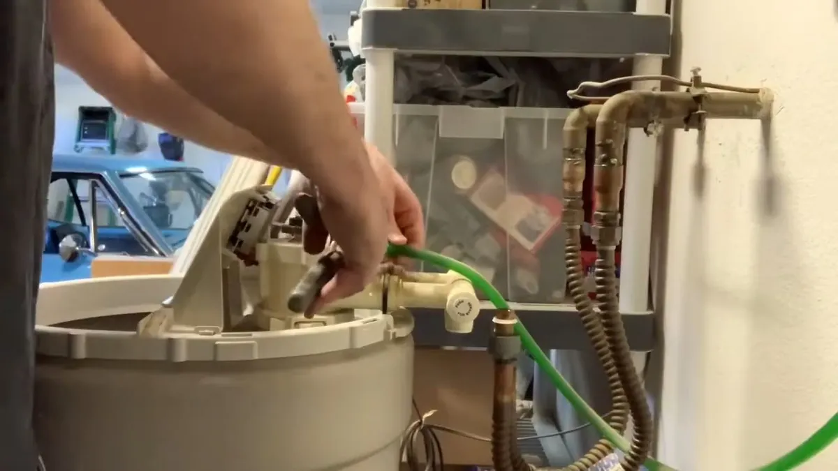 Technician servicing a residential water softener for water softener installation repair in Laguna Niguel